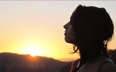 Woman admiring a beautiful sunset