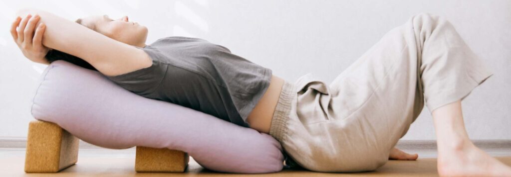 Dru Yoga Fascia Release woman resting in supportive somatic yoga