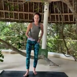 Aja Krystall leading a joyful movement yoga class for Dru Yoga, celebrating the body with kindness and ease.