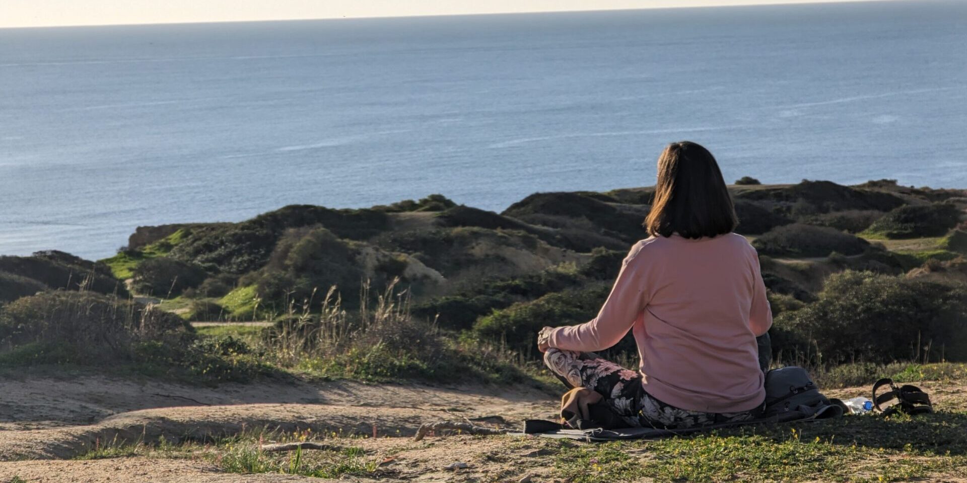 meditating woman cliff portugal