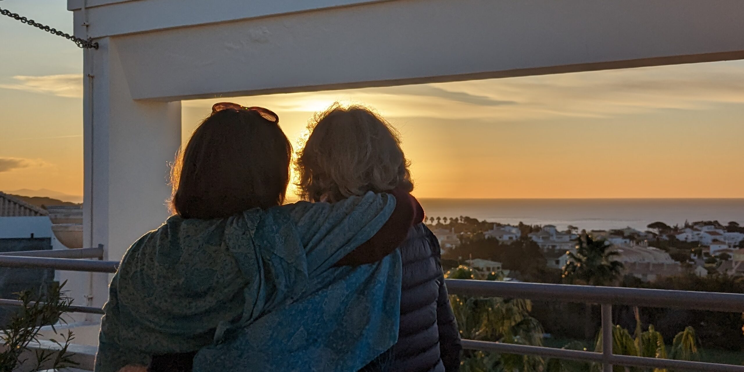 two women hugging portugal baia grande